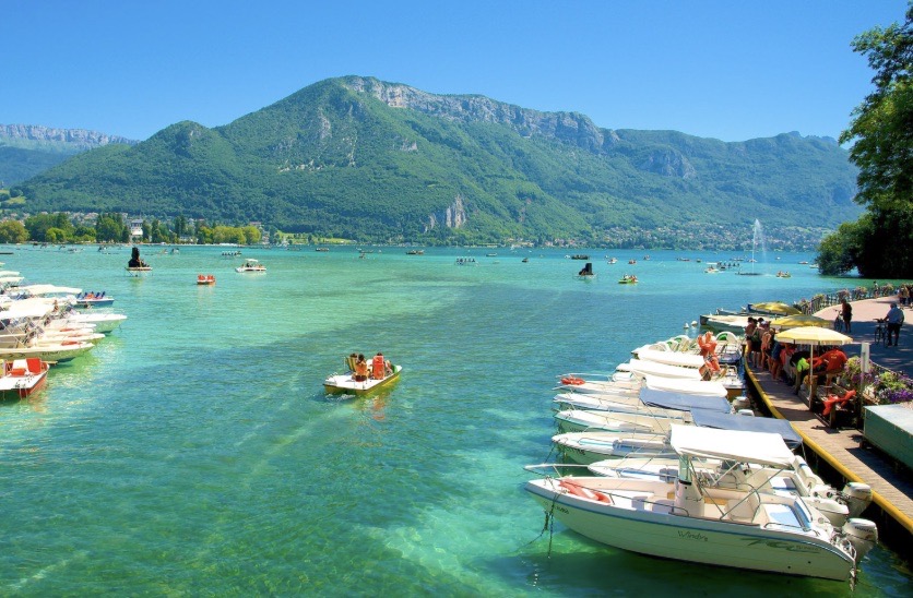 A margem do Lac d’Annecy, com barcos fundeados em águas turquesa